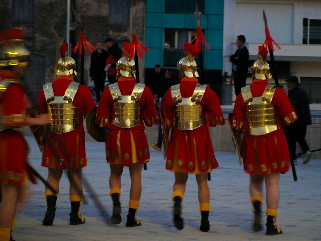 Reenactors dressed as Roman soldiers marching in formation